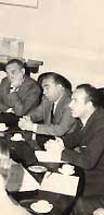 Black and white photo of authorities sitting at a table